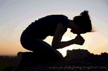 A woman on her knees praying